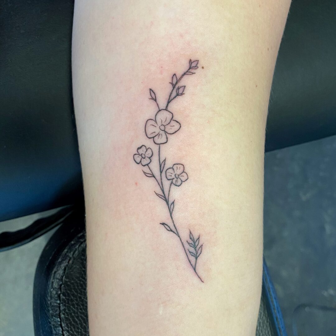 A tattoo of flowers on the arm.