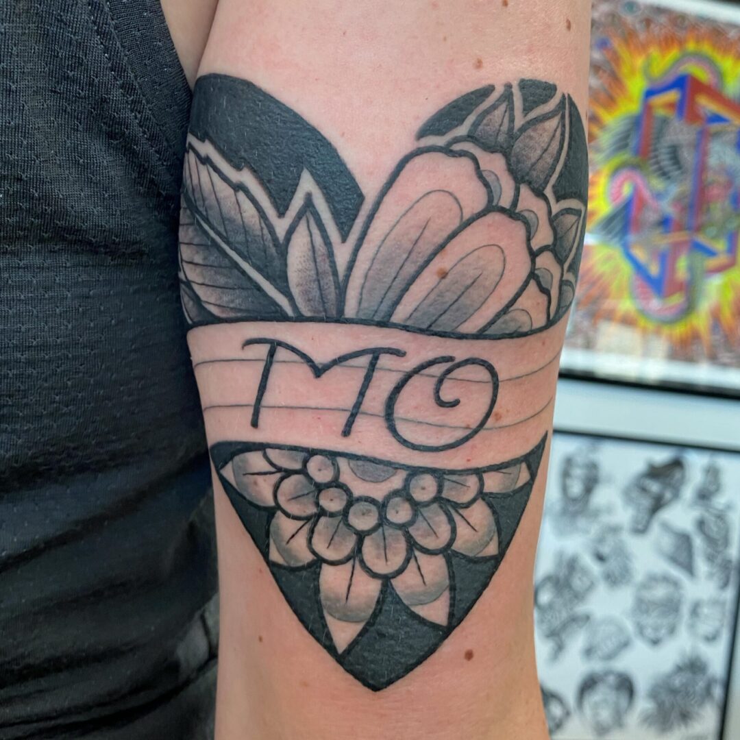 A tattoo of the name mo on a heart.