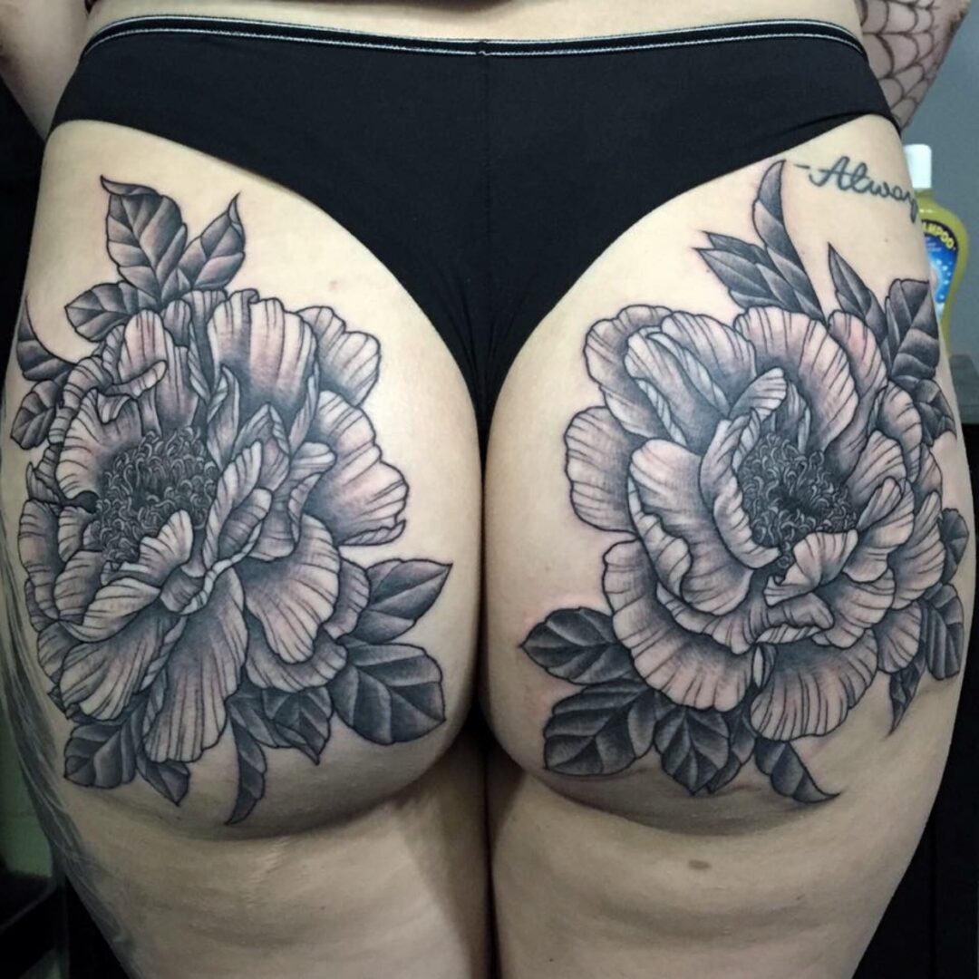 A woman with a tattoo of flowers on her butt.