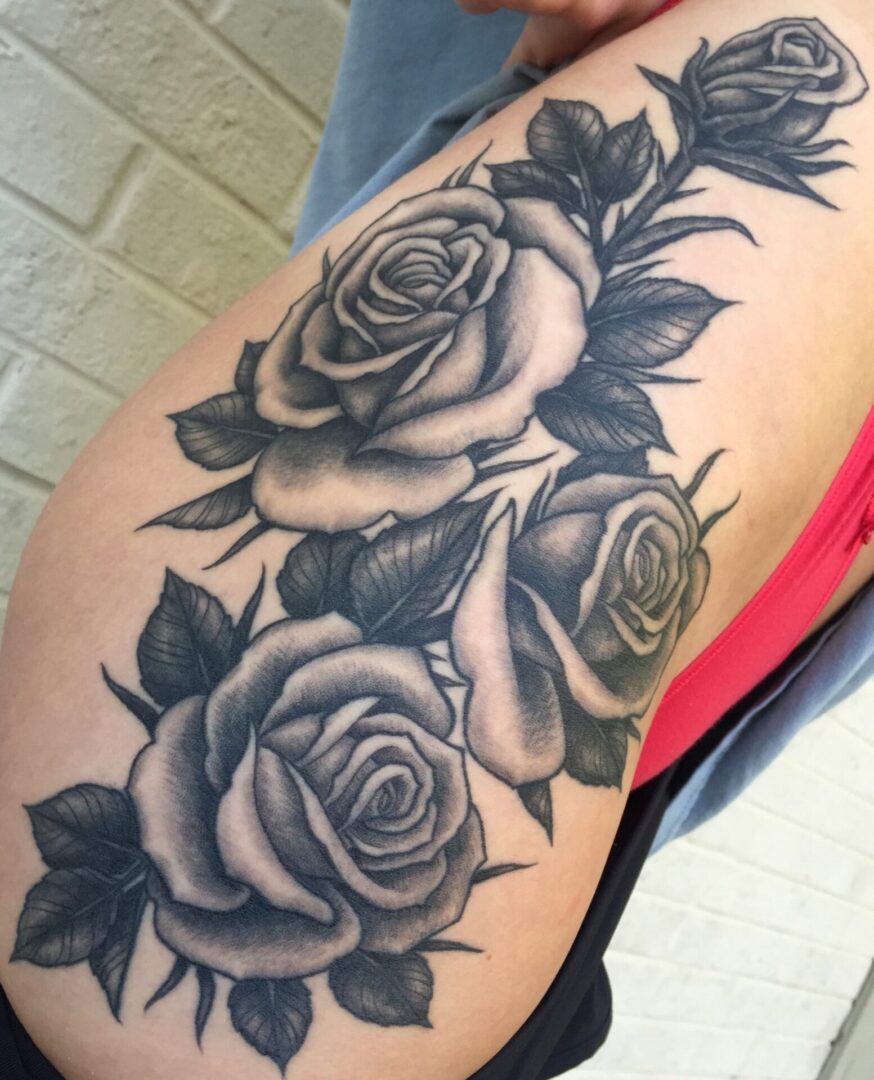 A woman with a tattoo of roses on her arm.