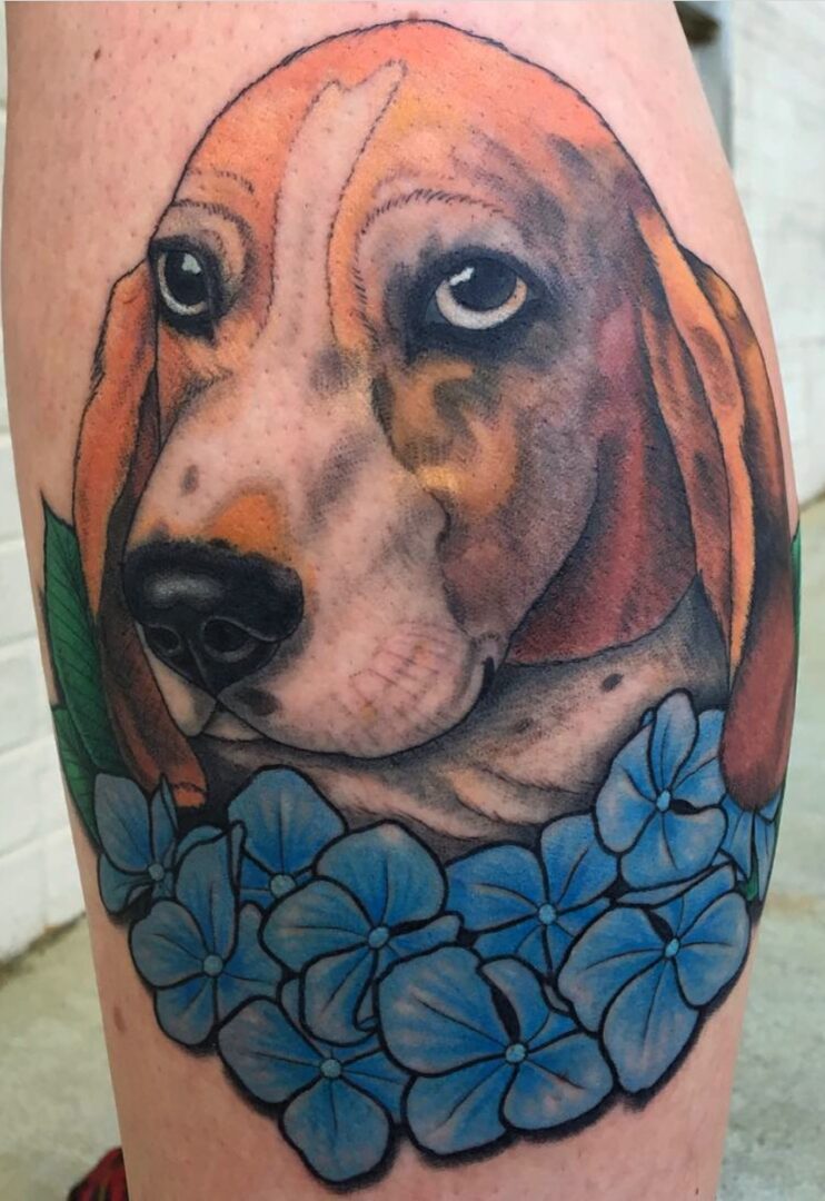 A dog with flowers on his arm