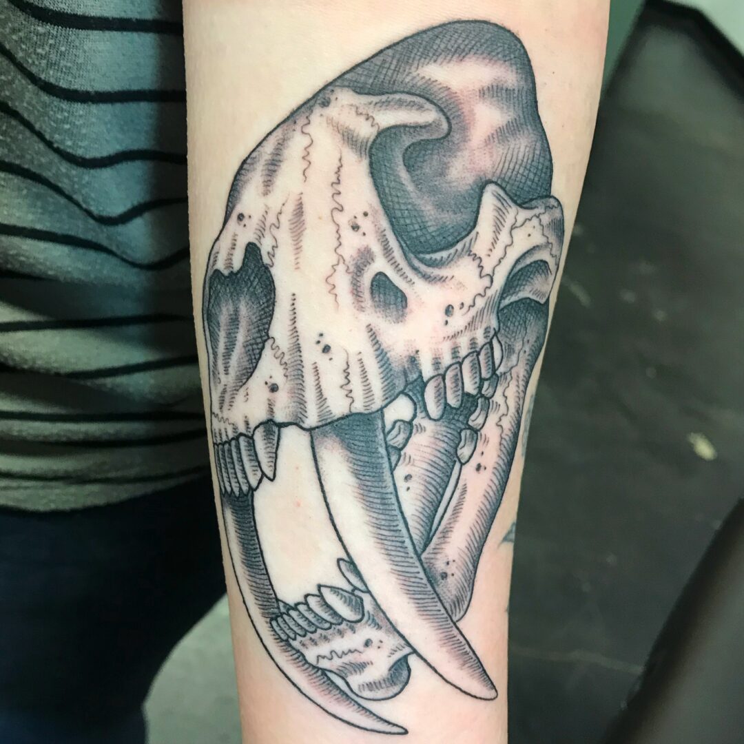 A tattoo of an animal skull with horns.