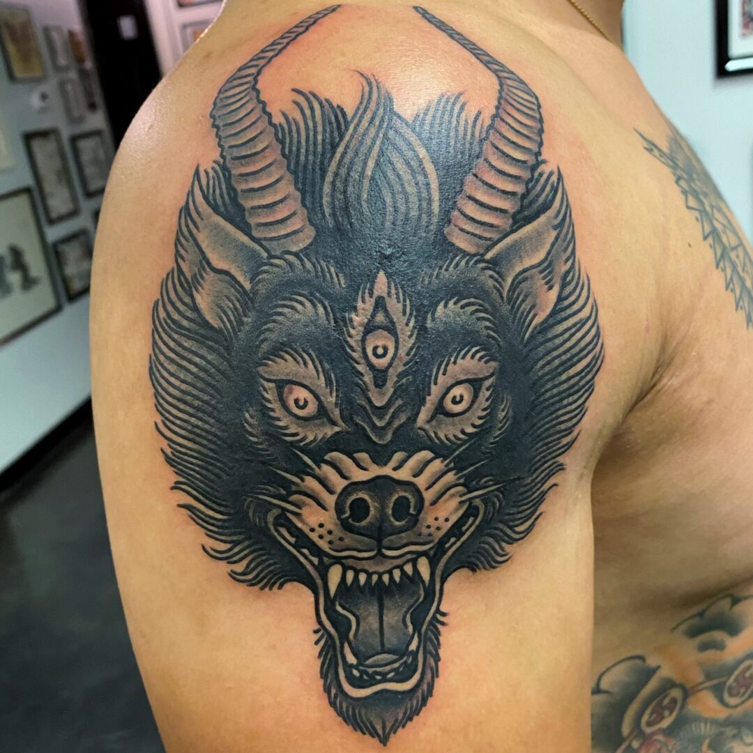 A man with a tattoo of an animal 's head.