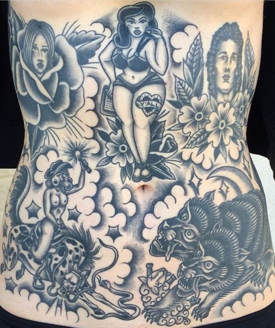 A woman 's stomach with various tattoos on it.