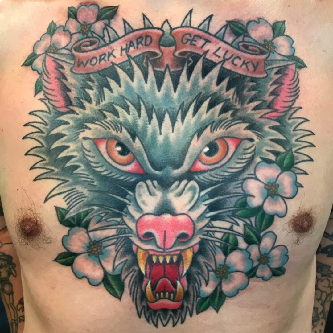 A tattoo of a wolf with flowers on it.