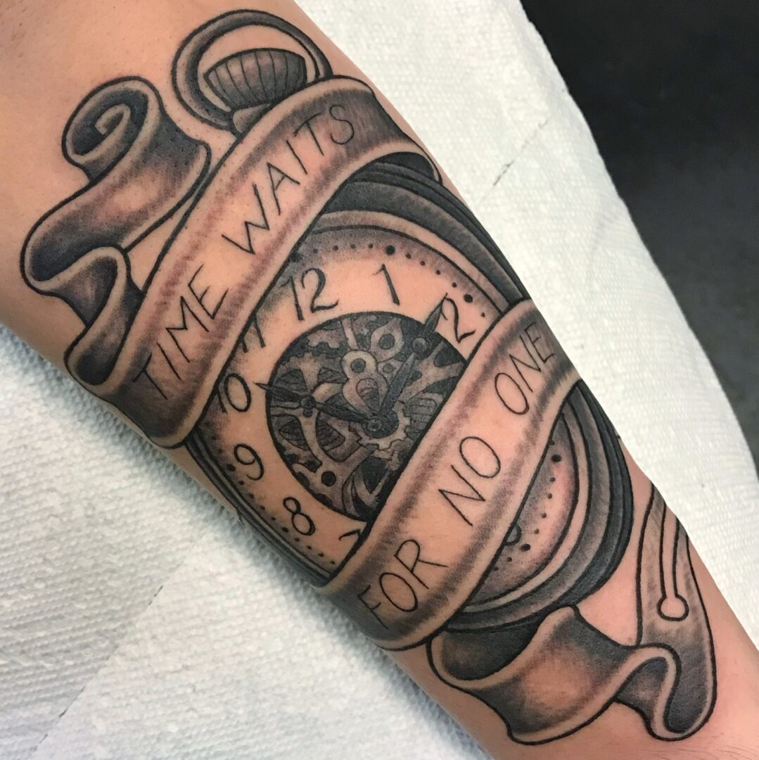 A tattoo of a clock with the words time waits for no one.