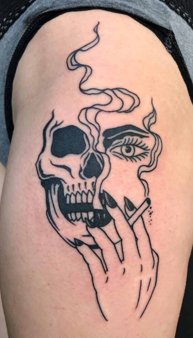 A black and white tattoo of a skull smoking