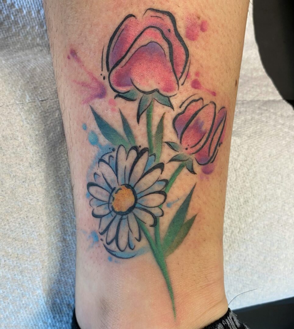 A tattoo of flowers and a daisy.