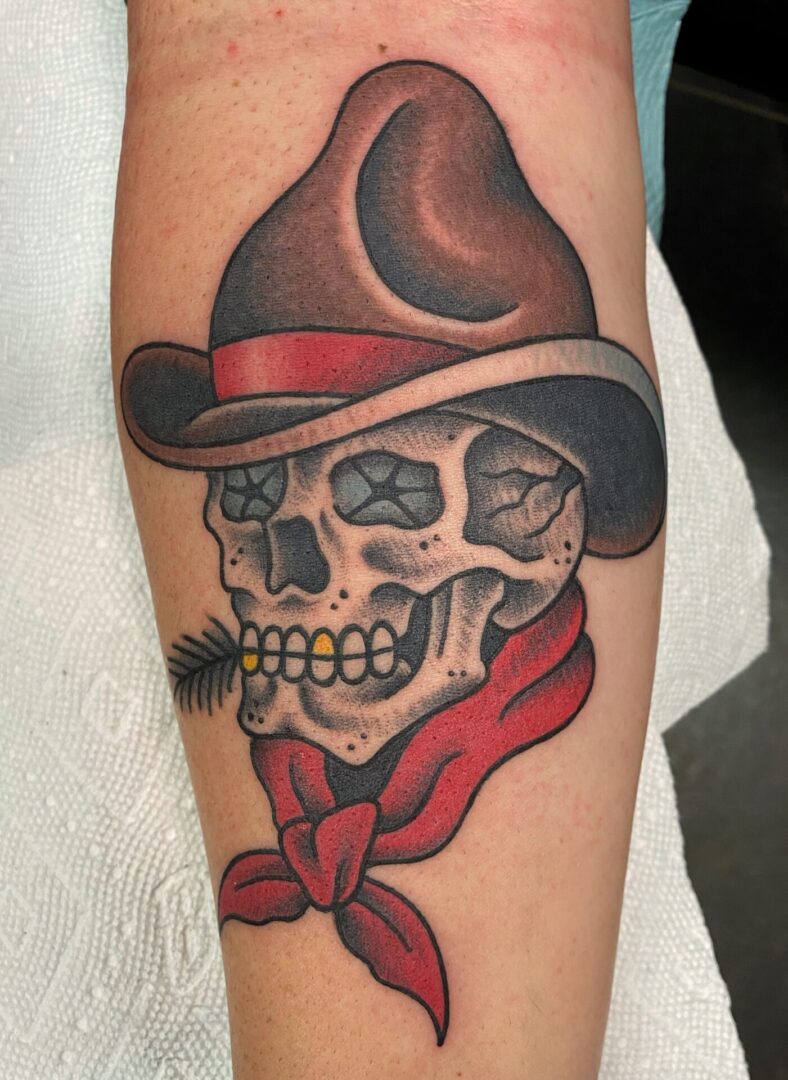 A skull with a cowboy hat and feather.