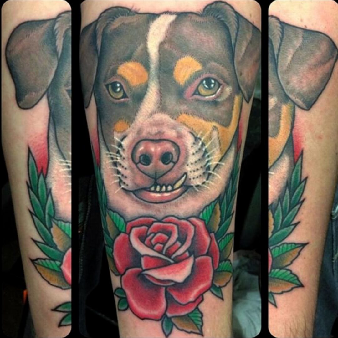 A dog with a rose tattoo on his arm.
