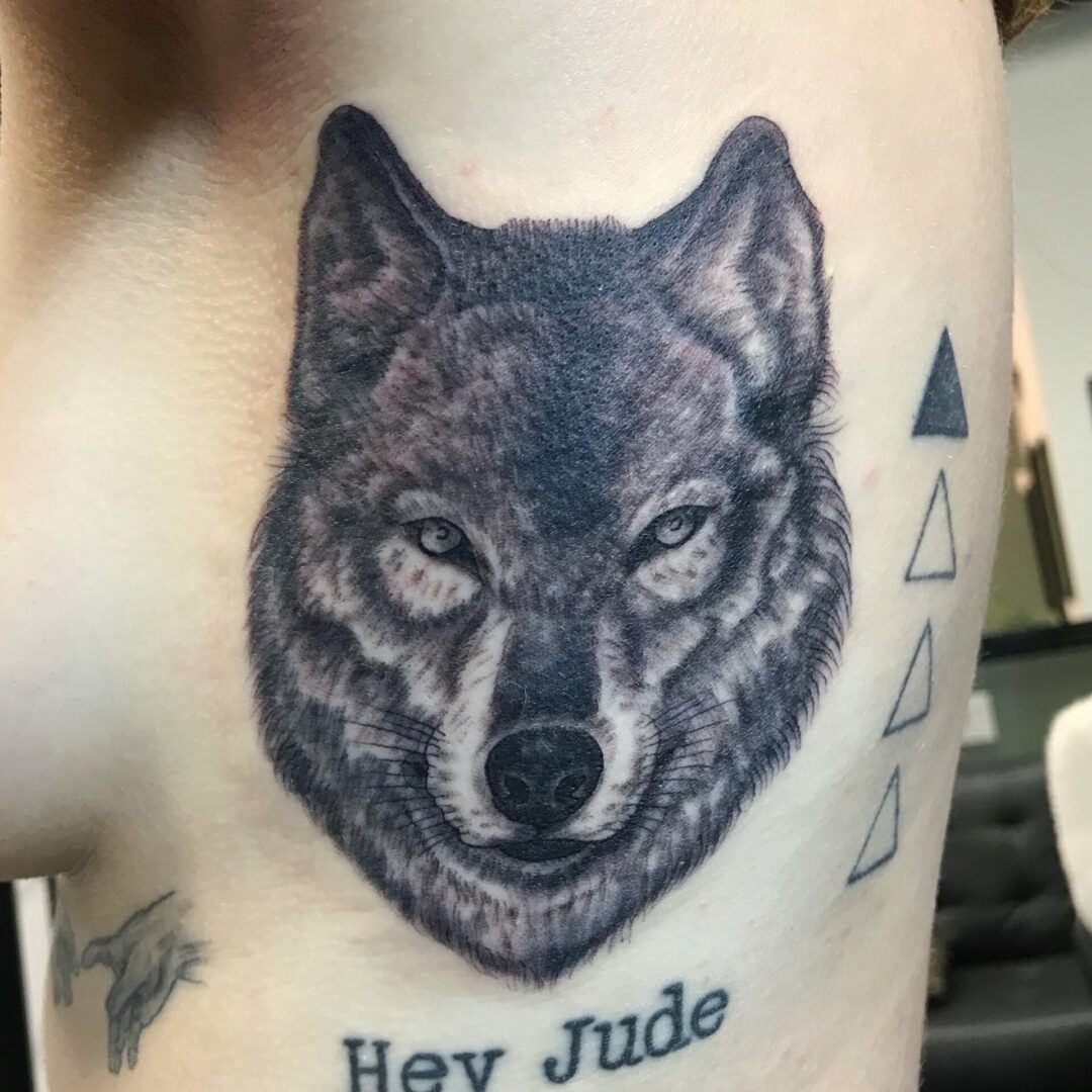 A wolf tattoo with the words hey jude on it.