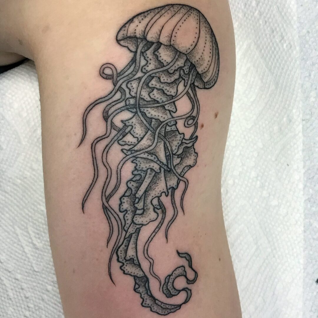 A black and white tattoo of an octopus