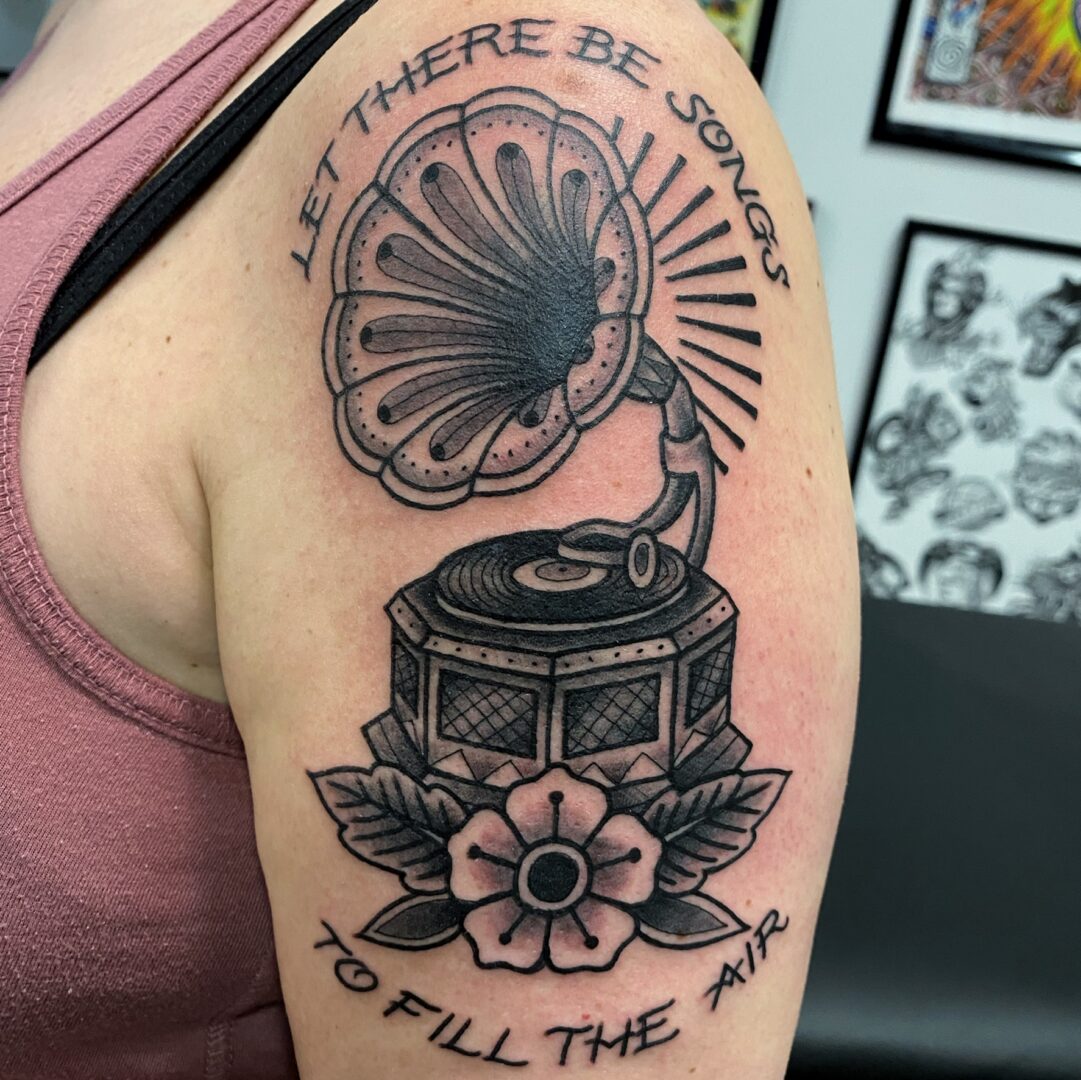 A woman with a tattoo of an old gramophone.