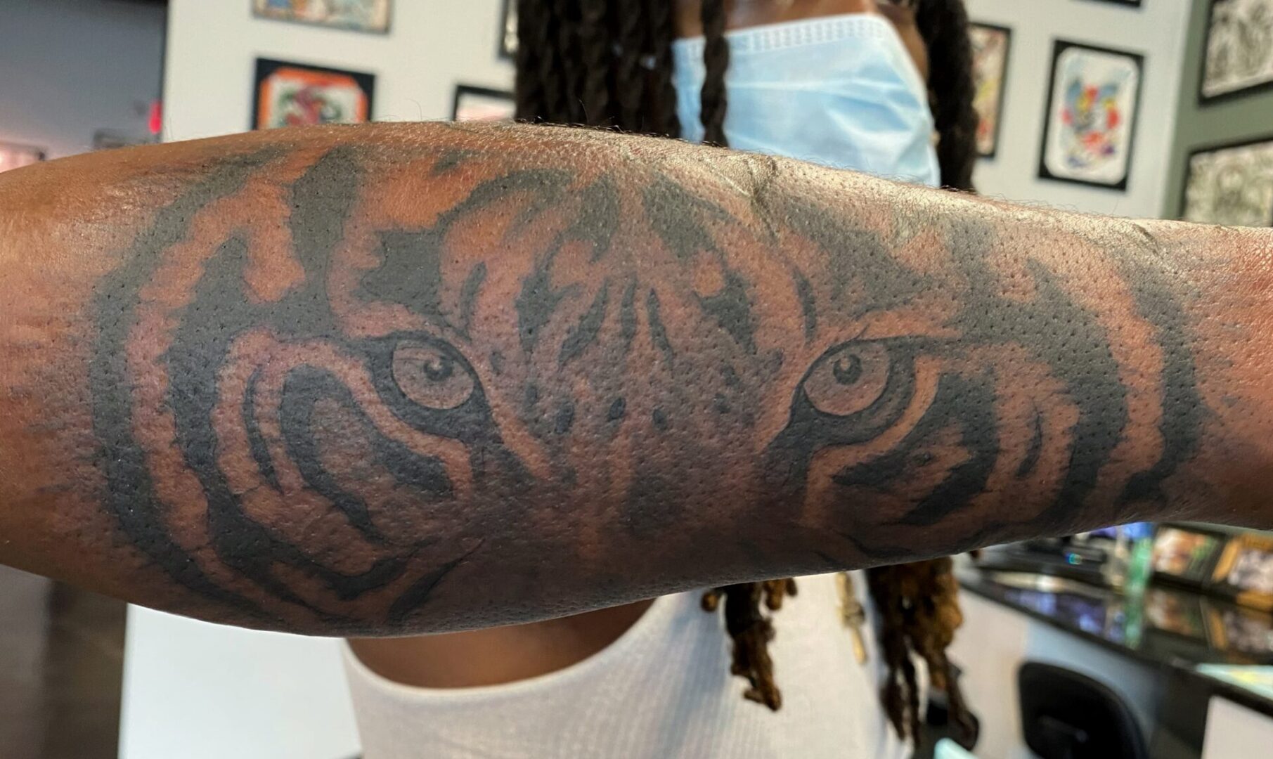 A person with tiger eyes on their arm