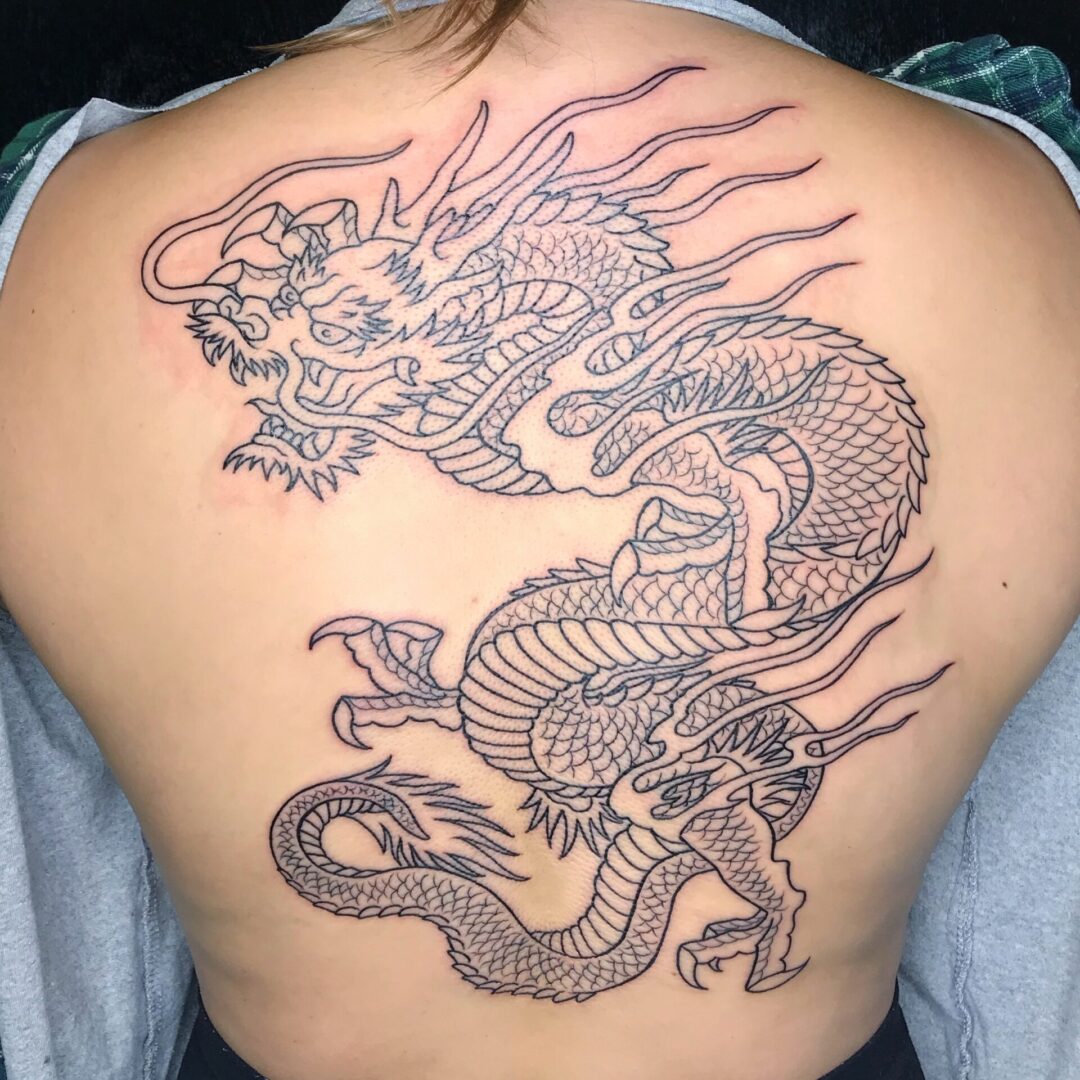 A person with a dragon tattoo on their back