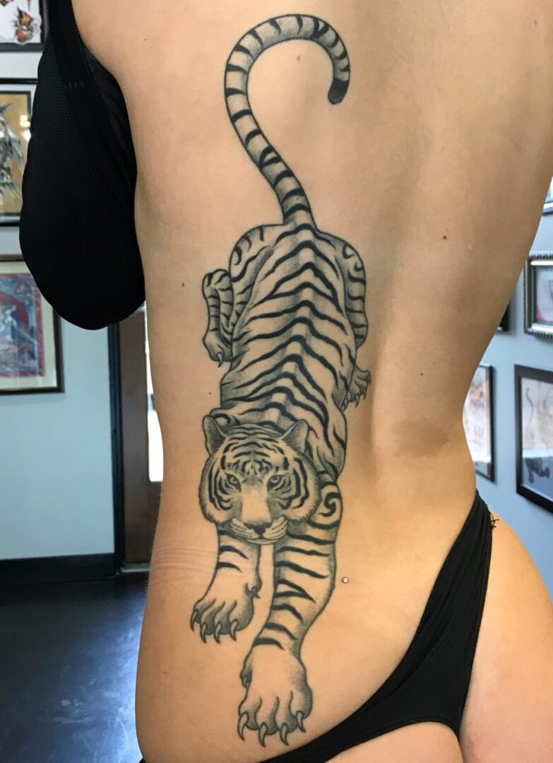 A woman with a tiger tattoo on her back