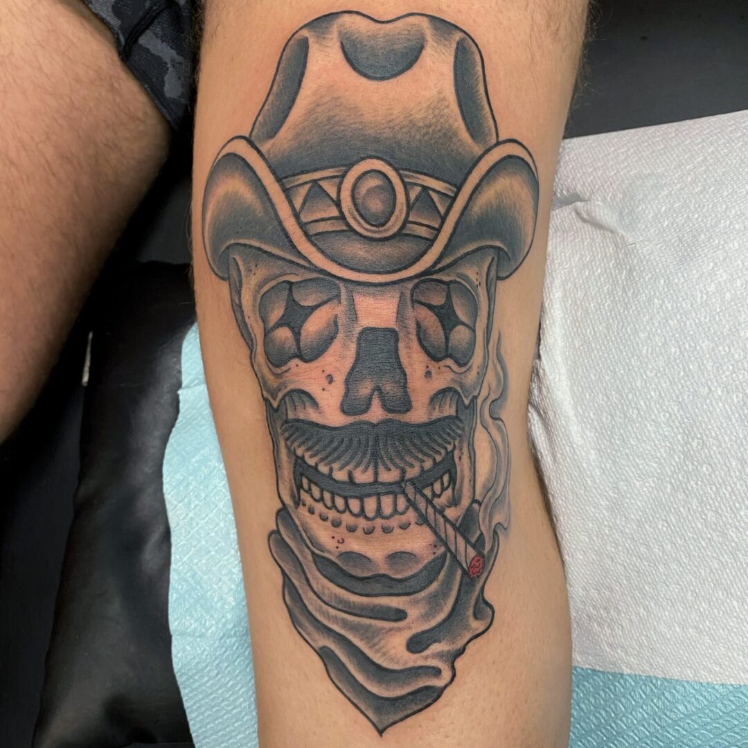 A tattoo of a skull wearing a cowboy hat.