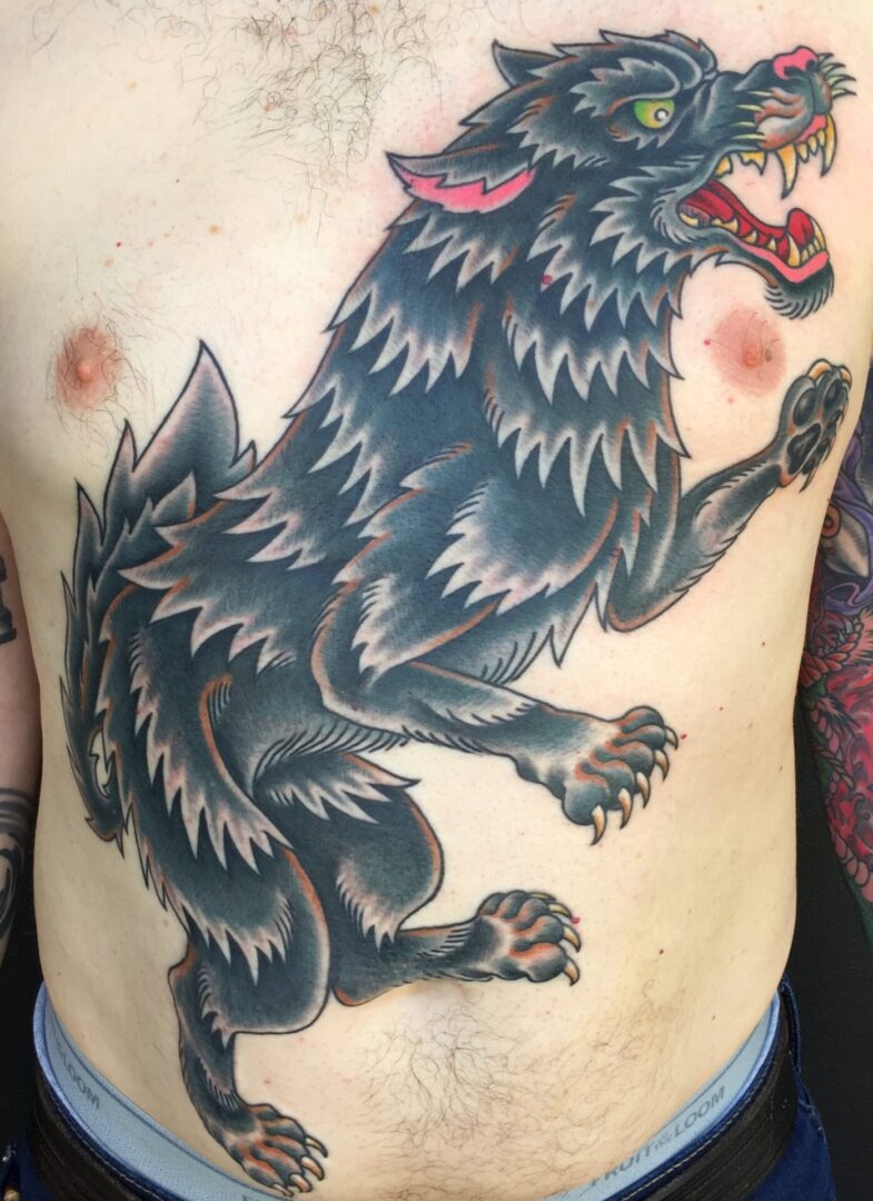 A tattoo of a wolf with red eyes.