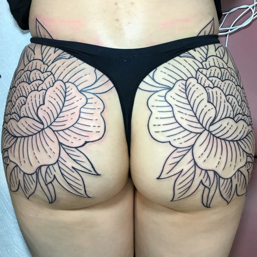 A woman with a tattoo on her butt.