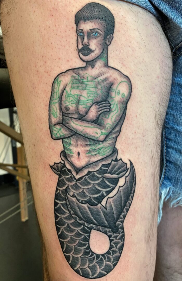 A man with green skin is standing on top of a fish.