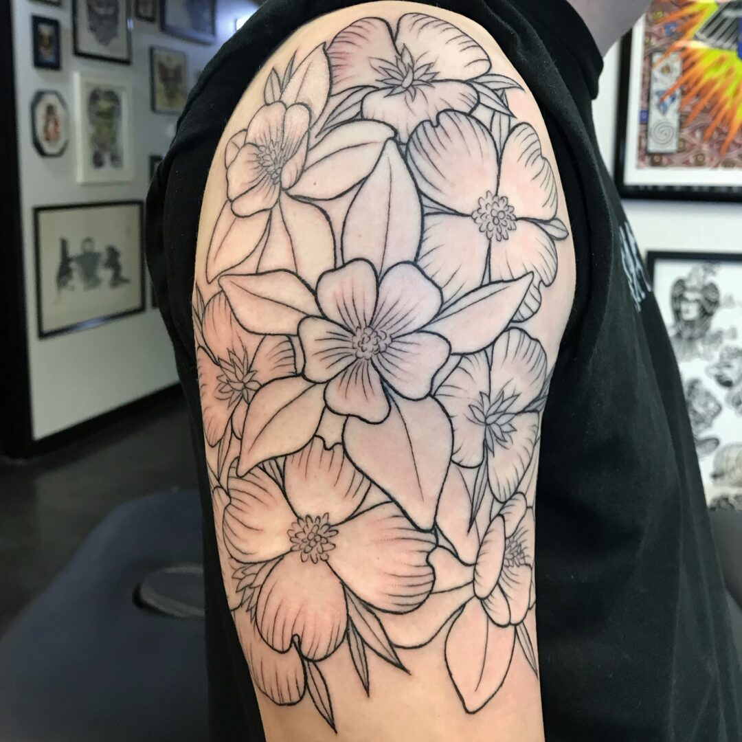 A person with a tattoo of flowers on their shoulder.