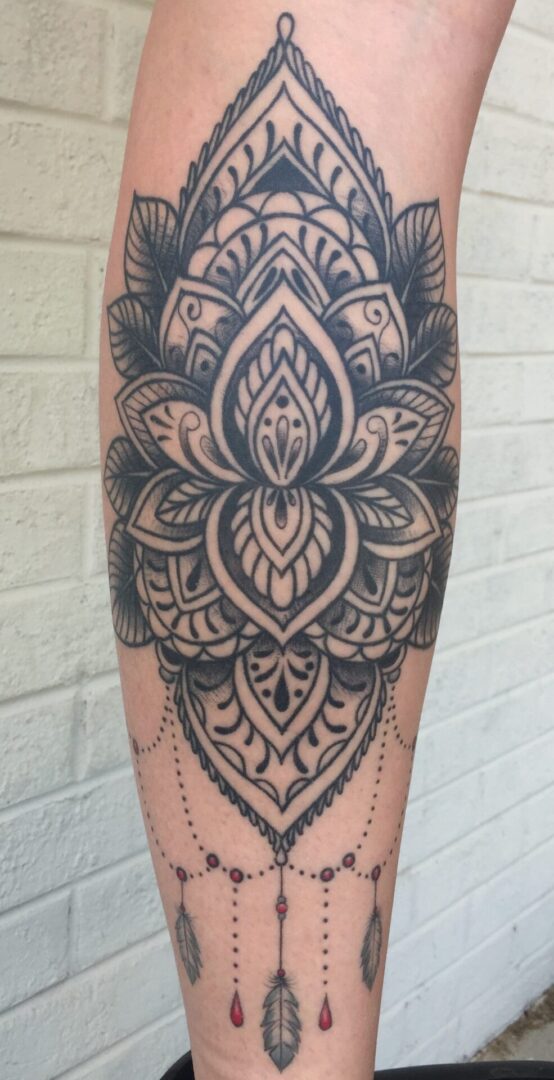 A black and white tattoo of an intricate design.