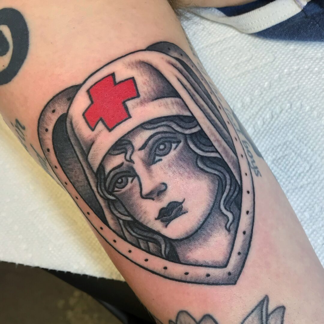 A woman with a red cross on her head.