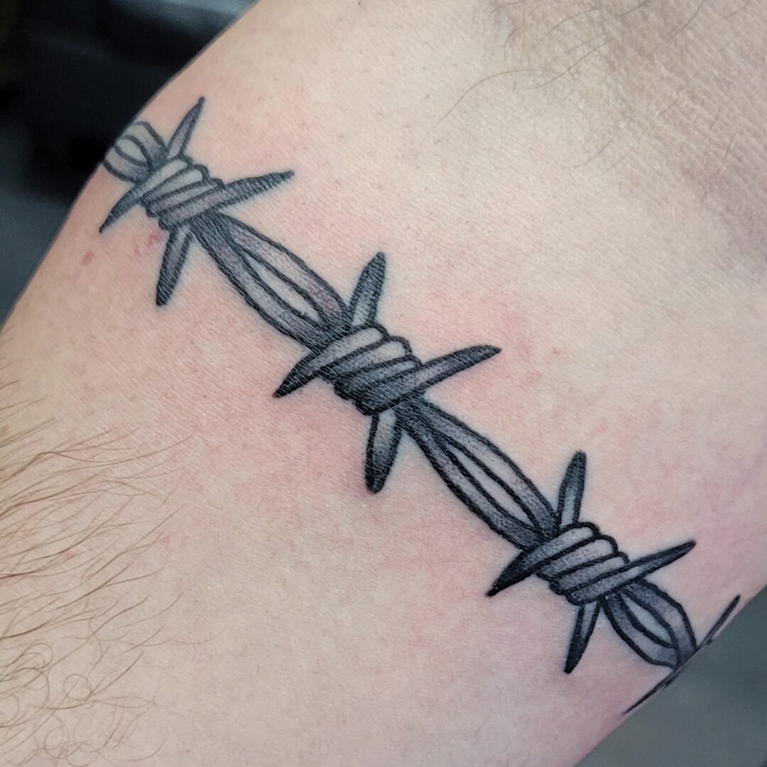A tattoo of barbed wire on the arm.