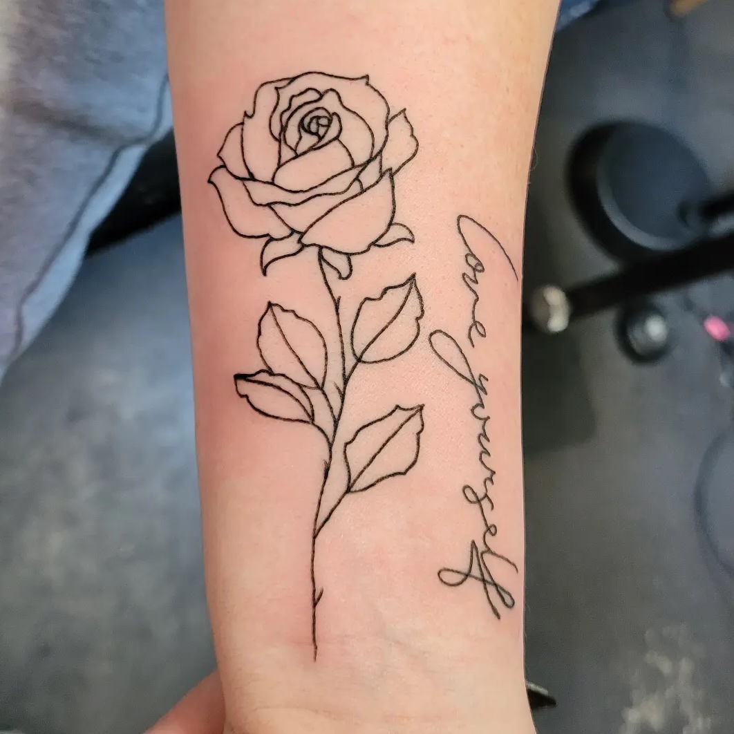 A rose tattoo with the words 